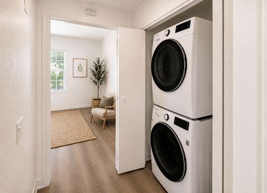 A white washing machine is in a doorway.
