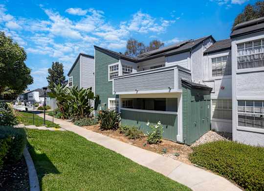 A row of houses with a green one in the middle.