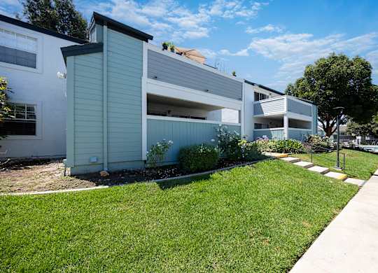 A row of modern houses with white and grey exteriors.