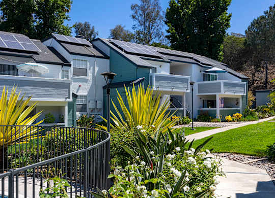 A row of houses with solar panels on the roofs.