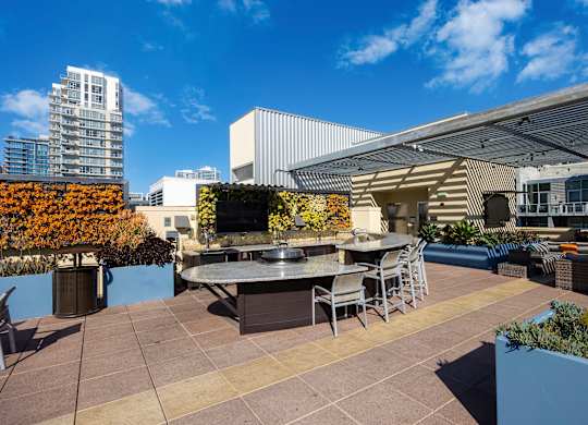 A patio with a table and chairs is surrounded by buildings.