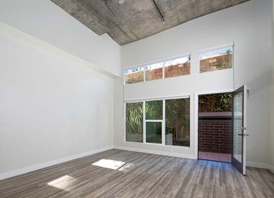 A room with a white wall and a wooden floor.