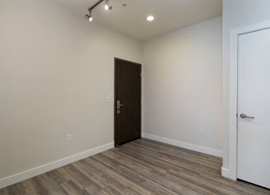 A room with a brown door and a white door.