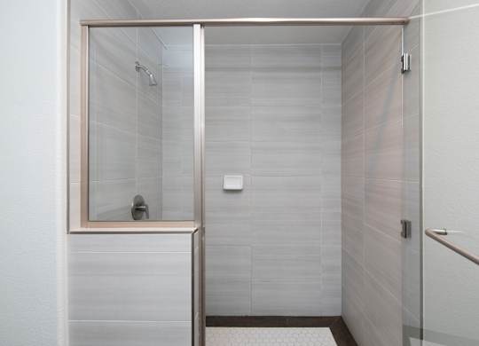 A white bathroom with a walk in shower.