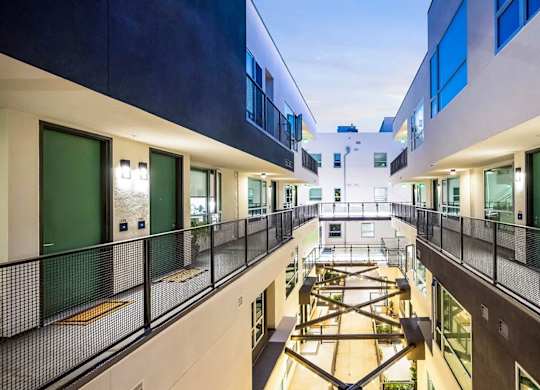 A modern building with a balcony and a playground.