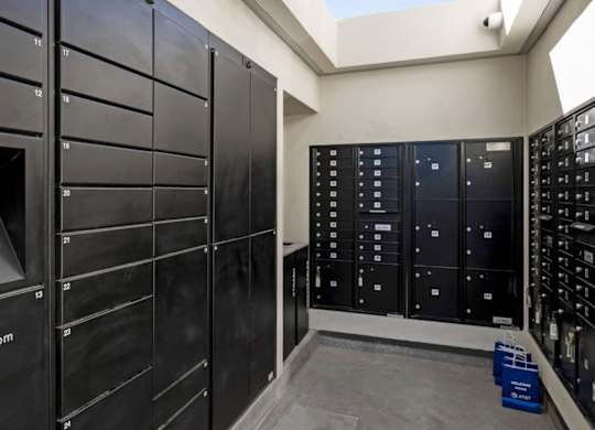 A row of black lockers with the word LuxerOne.com on the first one.