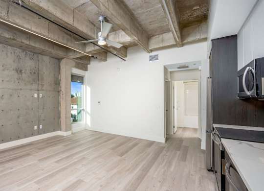 A room with a concrete wall and wooden floor.