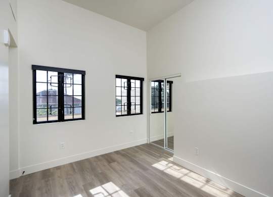 A room with a white wall and a wooden floor.