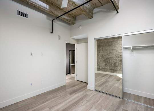 A room with a white wall and a wooden floor.