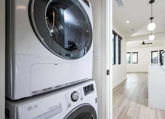 A white LG washing machine and dryer in a modern laundry room.