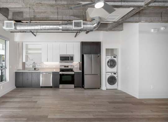 A modern kitchen with a washer and dryer built in.