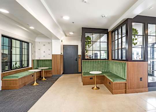 A long hallway with a bench and a door.