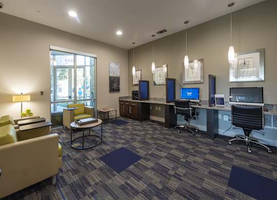 A conference room with a large table and chairs.