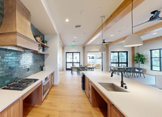 a large kitchen with a long counter top and a sink at The Villas at Anacapa Canyon, Camarillo, CA, 93012