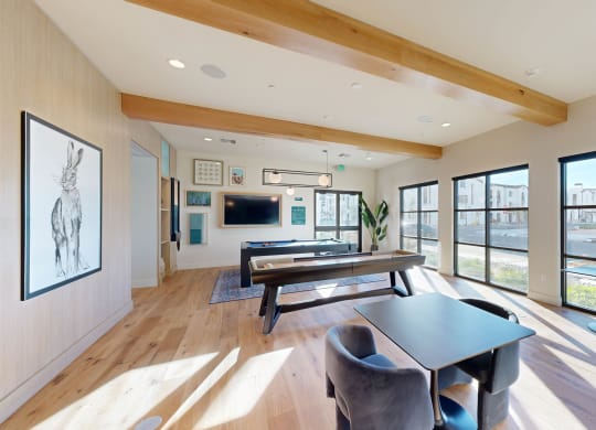 a living room with a table and chairs and large windows at The Villas at Anacapa Canyon, Camarillo