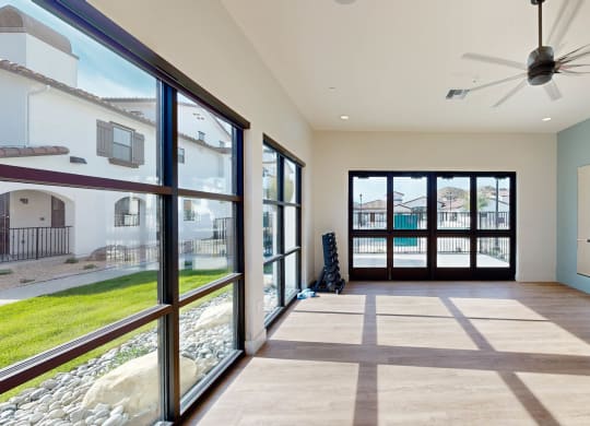 a living room with large windows and a ceiling fan at The Villas at Anacapa Canyon, California