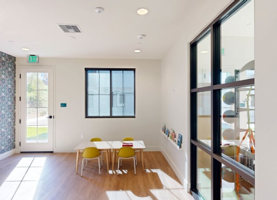a dining room with a table and chairs and a glass door at The Villas at Anacapa Canyon, Camarillo, CA, 93012