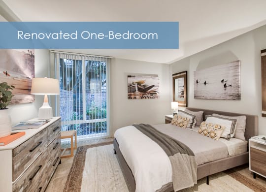 a bedroom with a bed and a window at The Meadows Apartments, Culver City