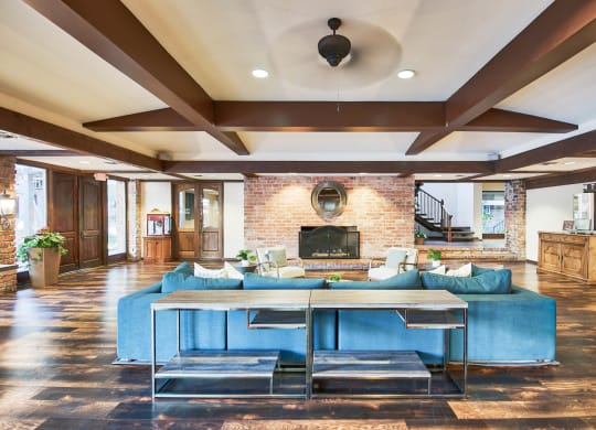 a living room with a blue couch and a table at The Meadows Apartments, Culver City , California