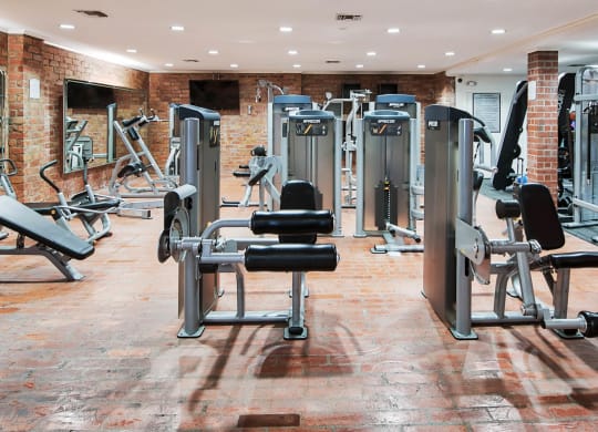 a gym with a lot of weights and cardio equipment at The Meadows Apartments, California, 90230
