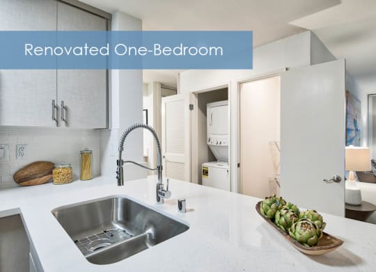a remodeled one bedroom kitchen with a sink and a bowl of vegetables at The Meadows Apartments, Culver City , California