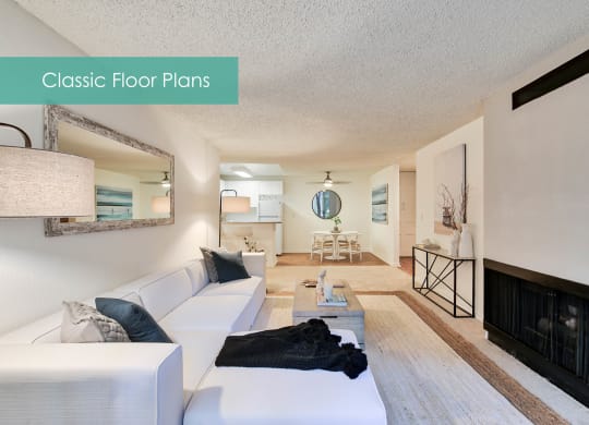 a living room with a white couch and a fireplace at The Meadows Apartments, California