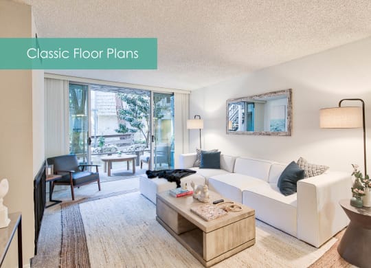 a living room with a white couch and a table at The Meadows Apartments, Culver City , 90230