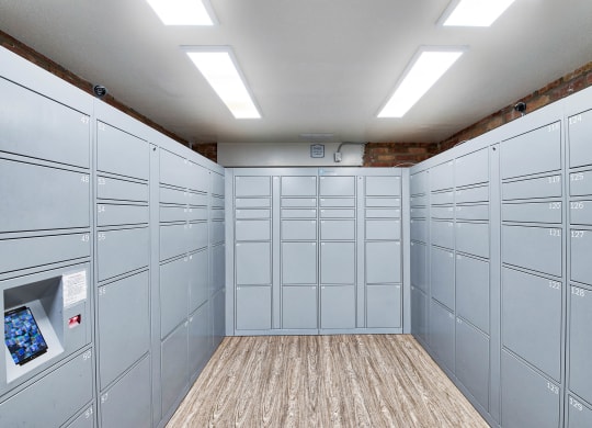 a bunch of white lockers in a room with a wood floor at The Meadows Apartments, Culver City , CA 90230