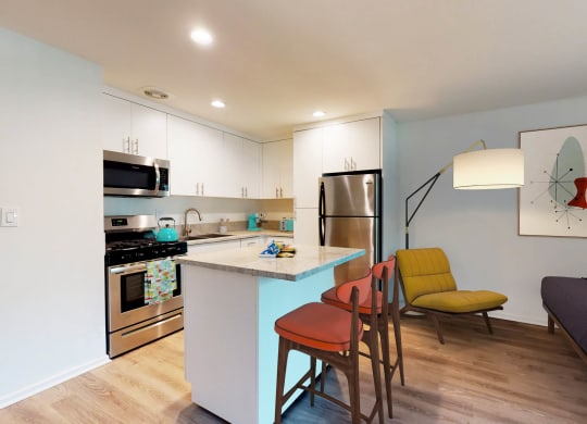 a kitchen with a bar and a counter top with chairs  at Rancho Los Feliz, California, 90039