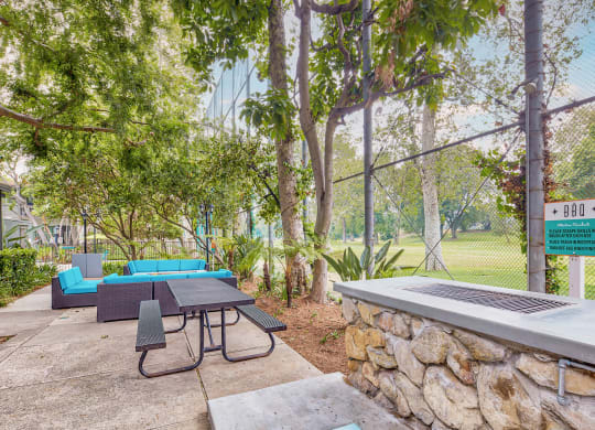 a patio with a table and chairs and a fire pit  at Rancho Los Feliz, Los Angeles