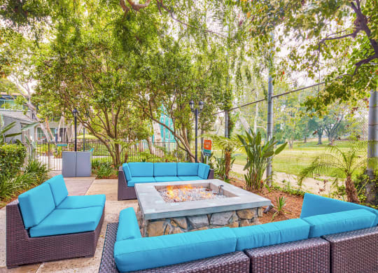 a lounge area with blue couches and a fire pit  at Rancho Los Feliz, California