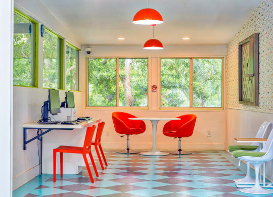 an office with red chairs and a table with a computer  at Rancho Los Feliz, Los Angeles, CA, 90039
