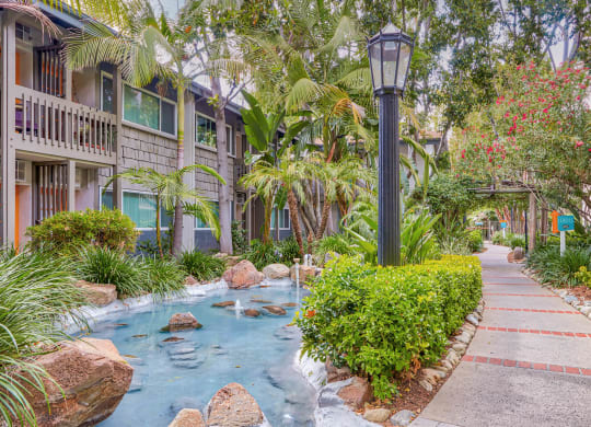 a sidewalk with a water feature in front of a building  at Rancho Los Feliz, California