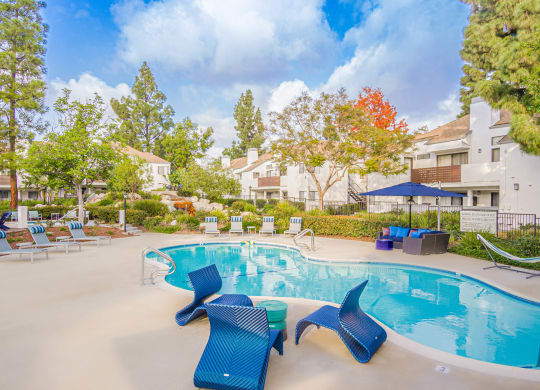 our apartments offer a swimming pool with chairs and umbrellas at Sendero Huntington Beach, Huntington Beach, 92647
