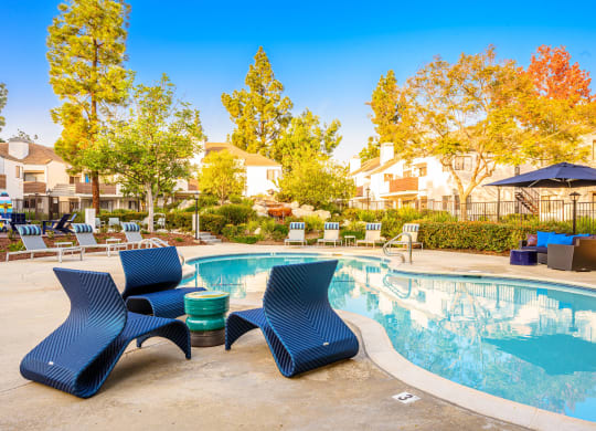 our apartments have a resort style pool with lounge chairs at Sendero Huntington Beach, Huntington Beach California