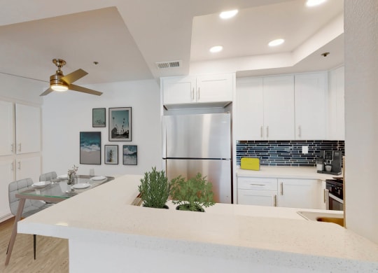 a kitchen with a white counter top and a stainless steel refrigerator at Sendero Huntington Beach, California, 92647