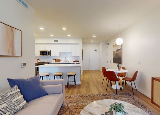 a living room with a couch and a table with chairs at The Villas at Anacapa Canyon, Camarillo, 93012