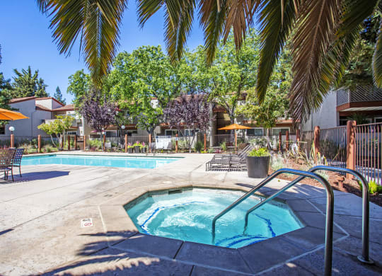 our apartments have a swimming pool and a patio with umbrellas at Valley Plaza Villages, Pleasanton, 94566