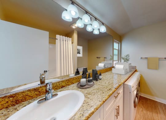 a bathroom with two sinks and a large mirror at Valley Plaza Villages, Pleasanton