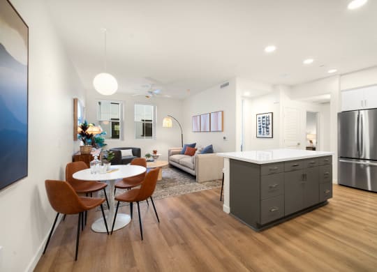 a living room with a kitchen and a table and chairs at The Villas at Anacapa Canyon, Camarillo, California