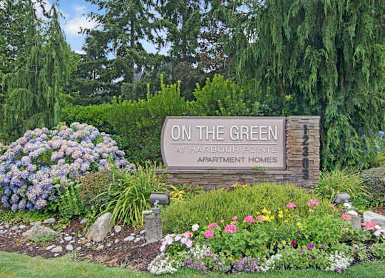 Landscaped monument sign at the entrance to On the Green at Harbour Pointe.