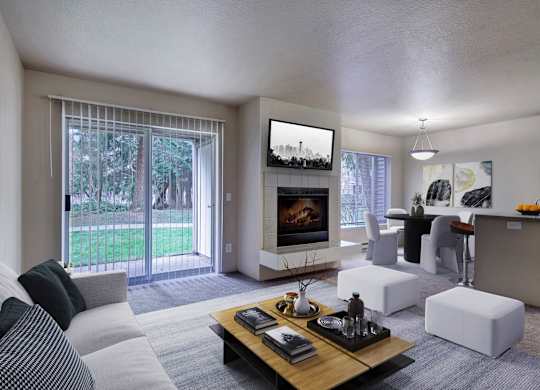 Open-concept living room with a fireplace, patio doors, and a dining area.