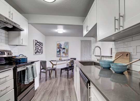 A modern kitchen with a dining table and chairs.