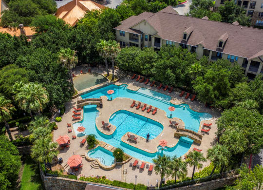 an aerial view of the resort style pool and lazy river at The Verandah, Austin, Texas