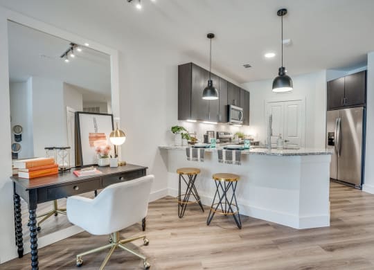 a kitchen and dining area in a 555 waverly unit at Aurora Watson Branch, Mansfield, TX, 76063