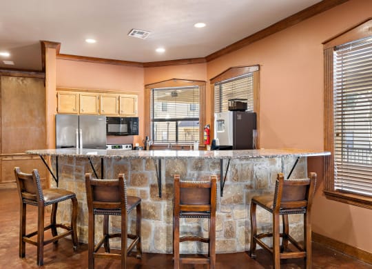 a kitchen with a bar and chairs at The Verandah, Texas