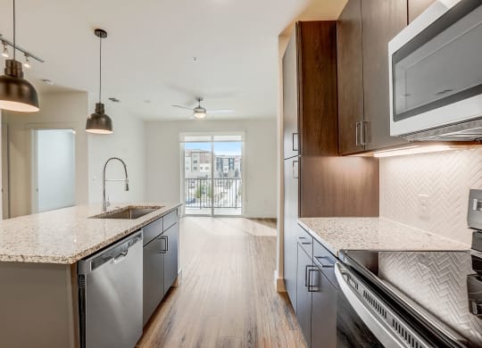 an open kitchen with marble counter tops and stainless steel appliances  at Aurora Watson Branch, Mansfield, 76063