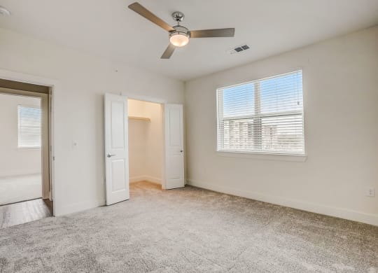an empty living room with a ceiling fan and a window at Aurora Watson Branch, Mansfield, 76063