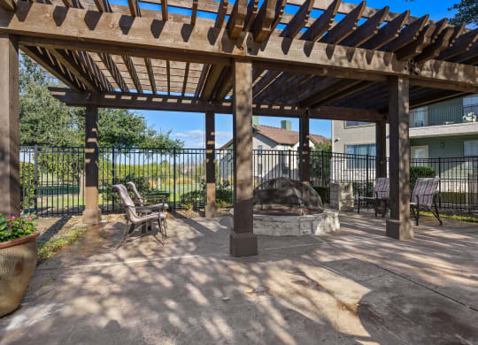 a patio with a fire pit and a pergola at The Fairways at Star Ranch, Hutto, Texas