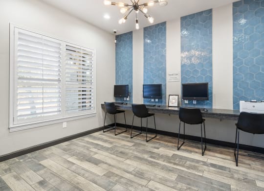 an office with three desks and three chairs and a window at Sonterra Apartment Homes, Austin, TX, 78726